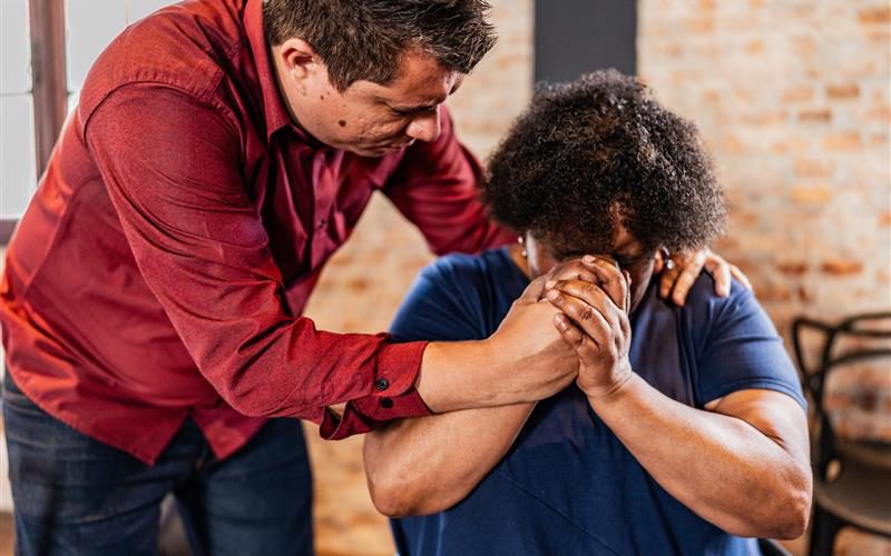 Two people praying together.