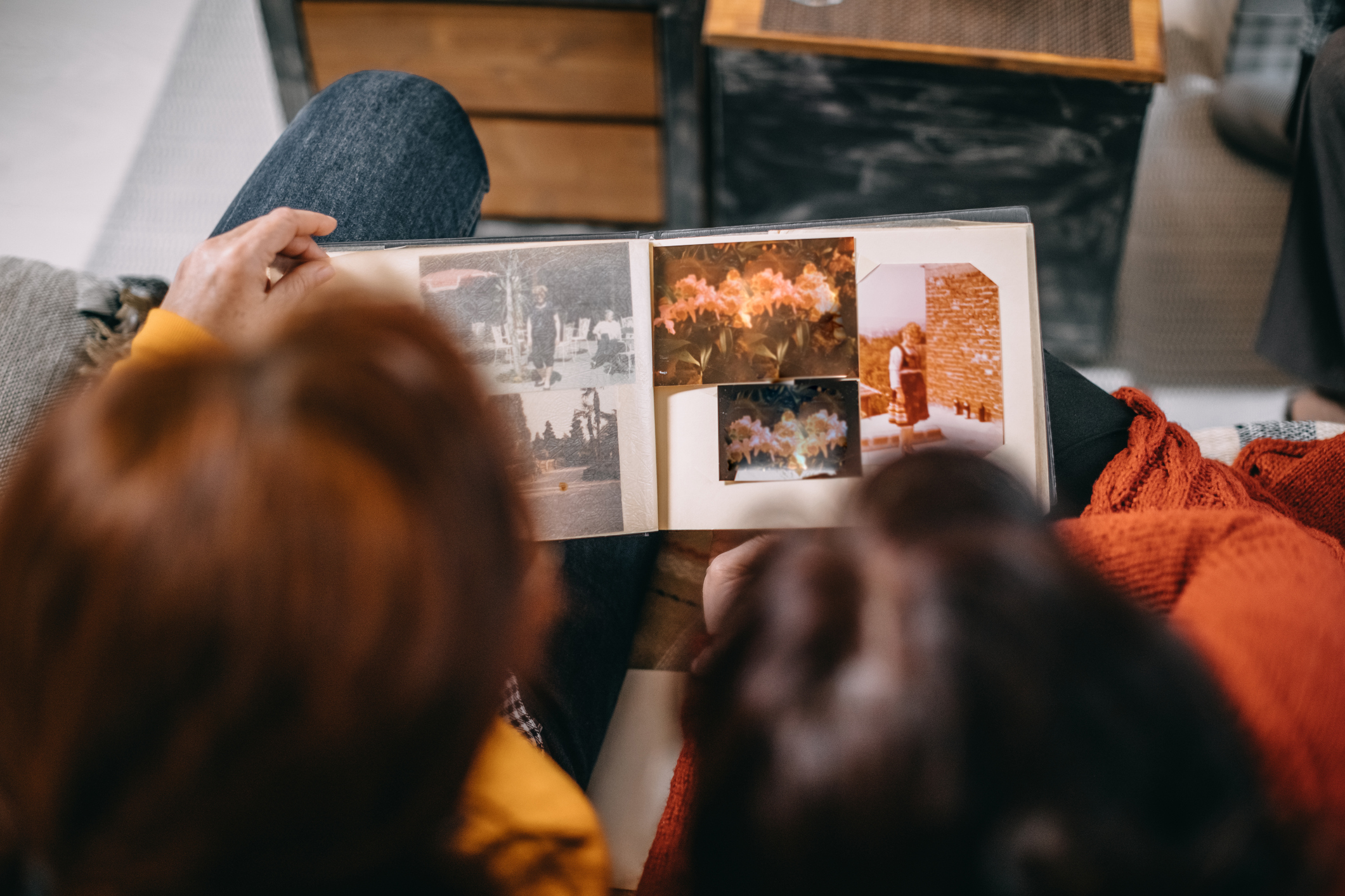 Two people looking at photo album with old photographs