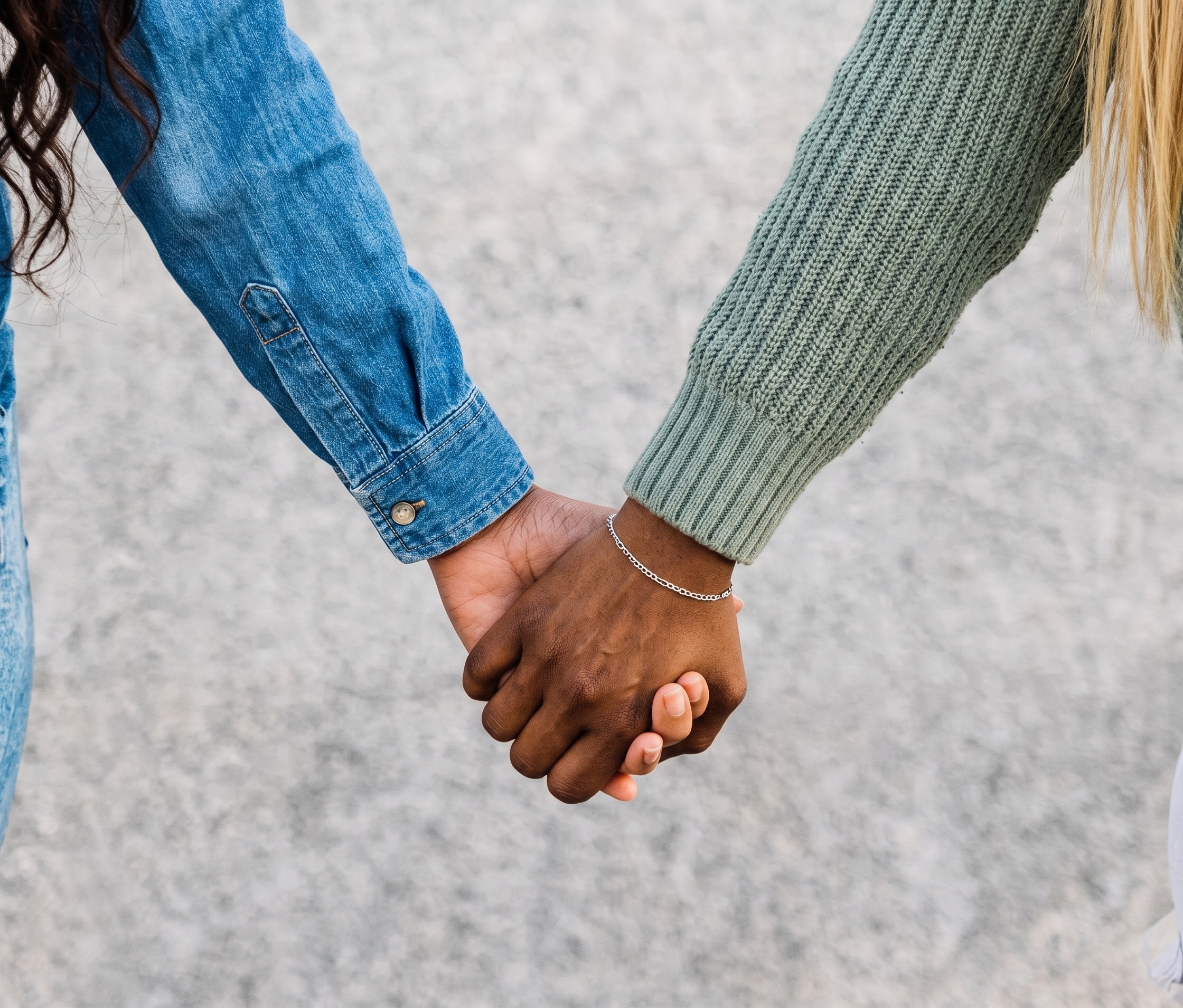 Close up of two women holding hands